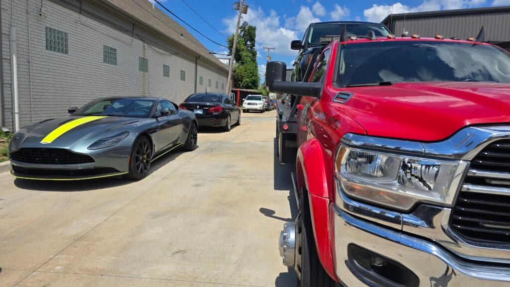 Red Neptune Towing flatbed truck providing professional Tulsa wrecker and emergency towing services in a residential Tulsa, OK neighborhood.